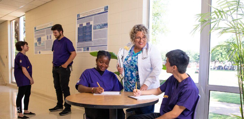 A nursing professor speaks to nursing students.