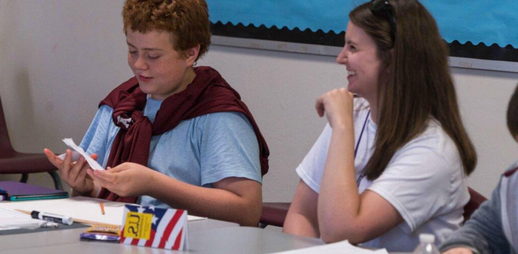 HSU students in class sharing notes and smiling